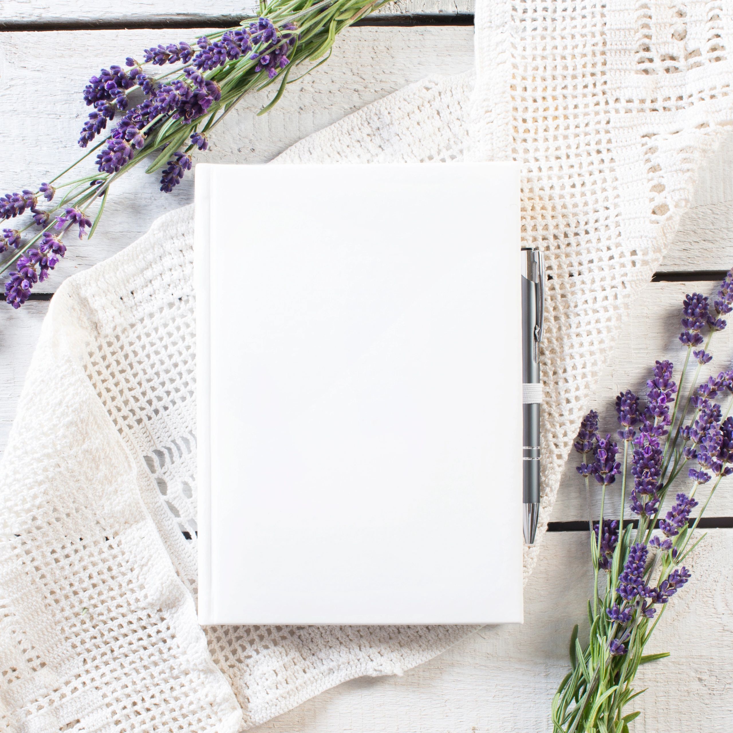 Lavender flowers arranged around an open devotional book
