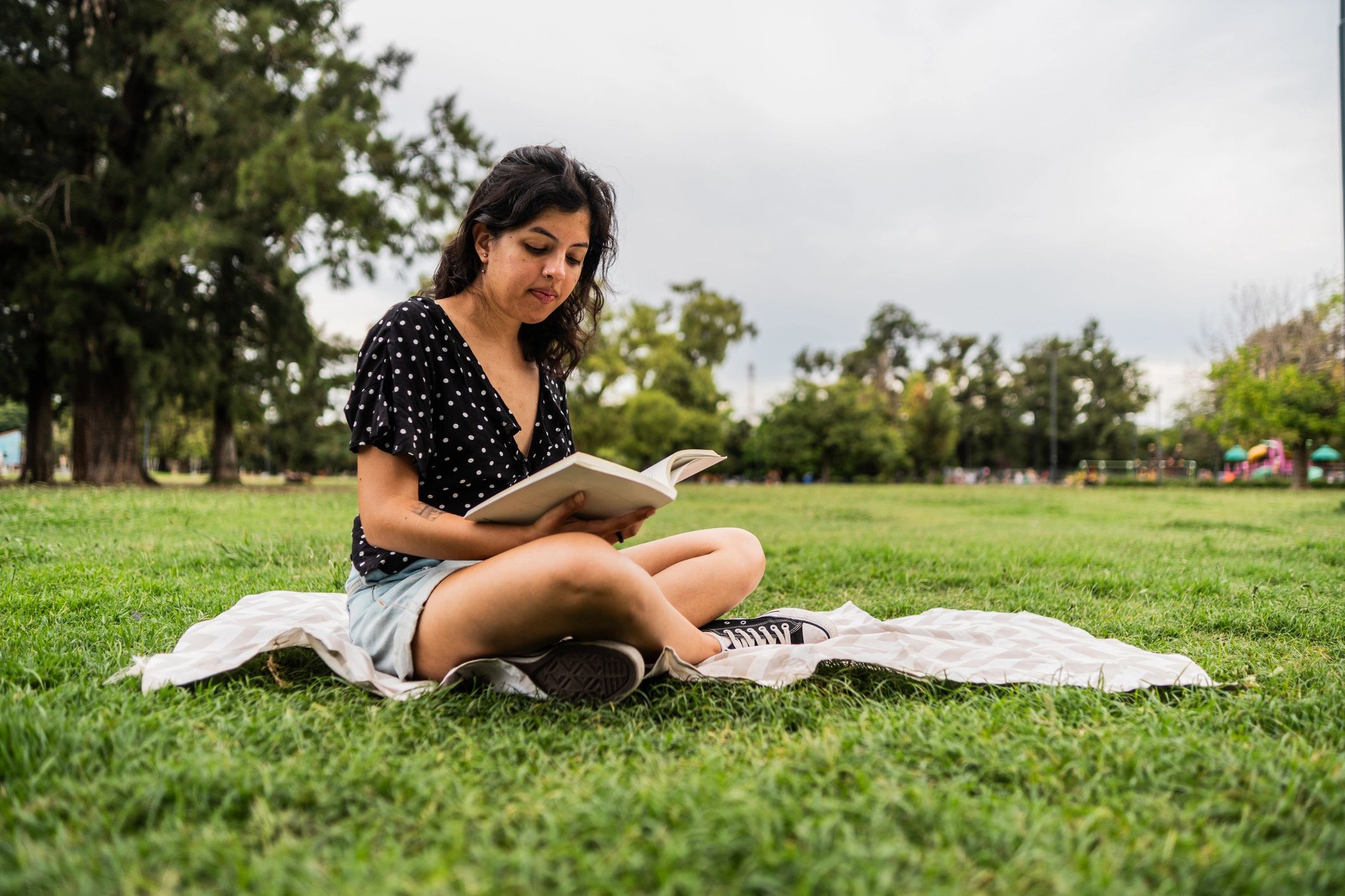 Woman reading outdoors in a peaceful park
